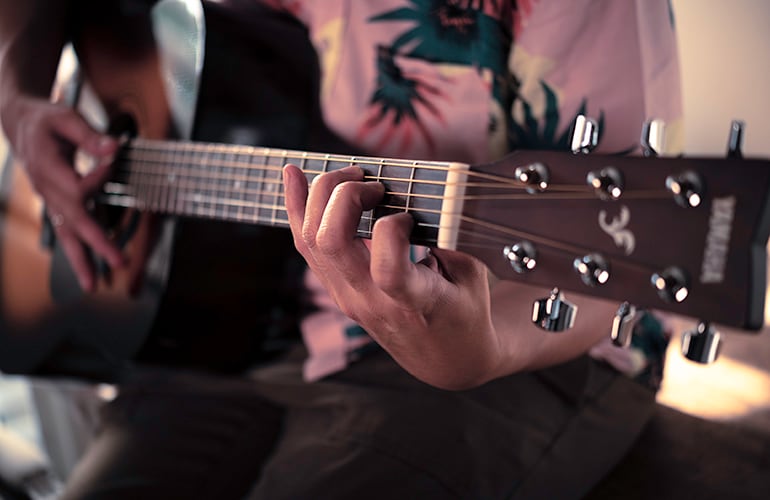 Person playing Beginner acoustic guitar, the yamaha f310