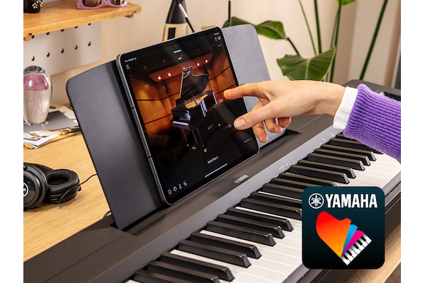 The Yamaha “Smart Pianist” app icon, with a tablet placed on the music stand of the P-145 digital piano
