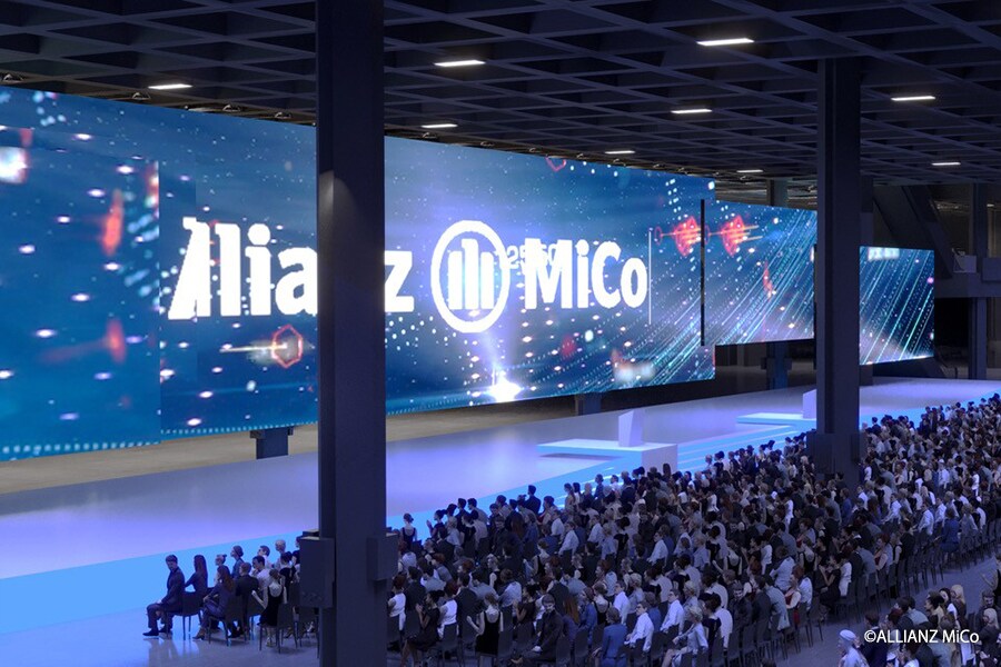 Wide view of a large-scale event at Allianz MiCo featuring a massive LED display and audience seating inside the congress centre.